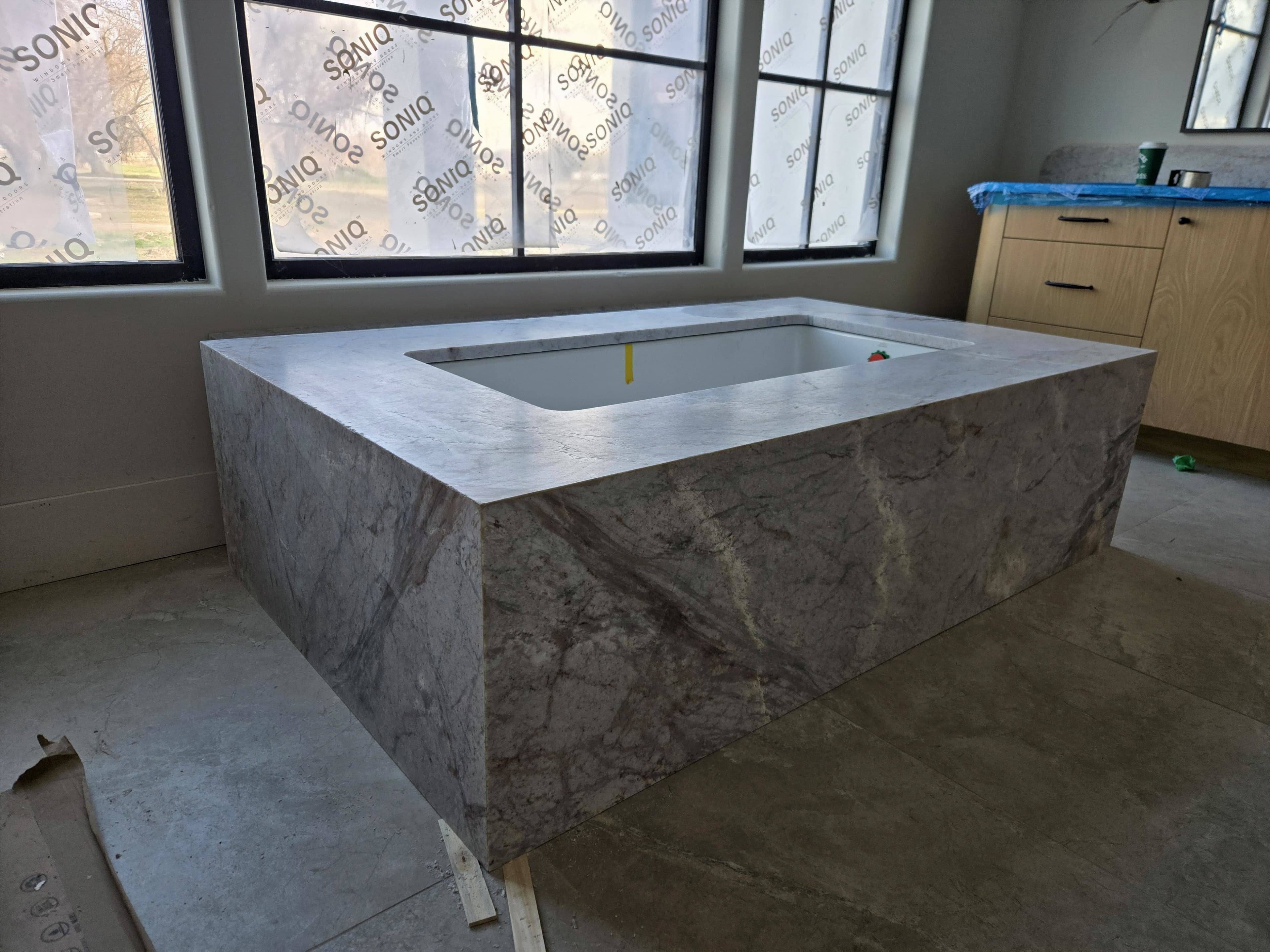 Stone-wrapped soaking tub